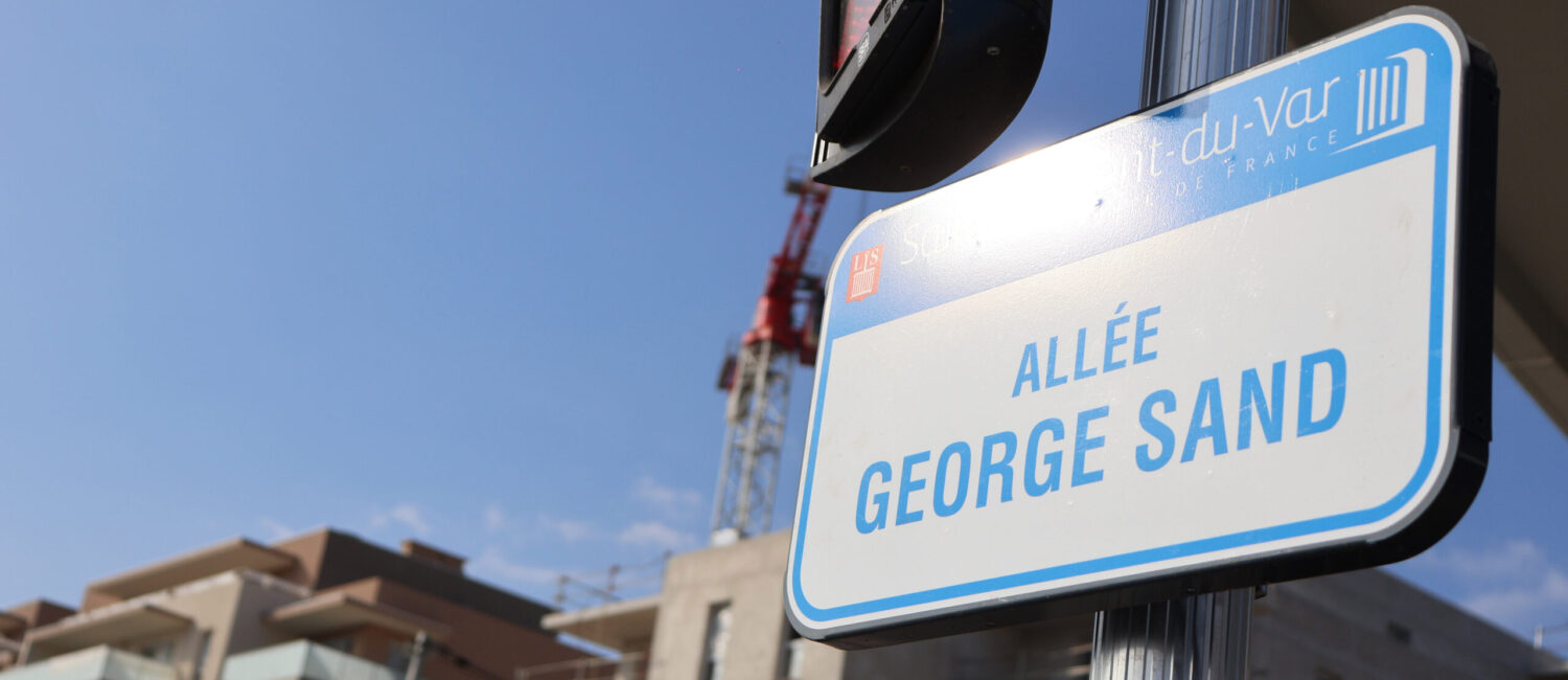 Cette image montre un panneau de rue où il apparaît le logo de la ville et "allée George Sand.